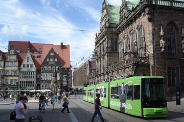Straßenbahn am Marktplatz in Bremen vor historischer Bebauung.  